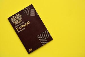 Red Portugal passport of European Union on yellow background close up photo