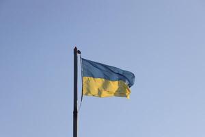 Ukraine flag large national symbol fluttering in blue sky. Large yellow blue Ukrainian state flag, Dnipro city, Independence Constitution Day photo