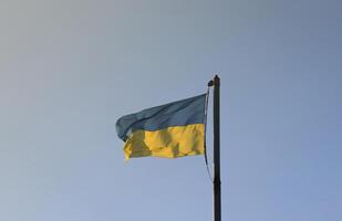 Ukraine flag large national symbol fluttering in blue sky. Large yellow blue Ukrainian state flag, Dnipro city, Independence Constitution Day photo