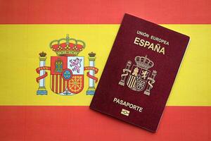 Red Spanish passport of European Union on national flag background close up photo