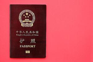 Red passport of People Republic of China. PRC chinese passport on bright background photo