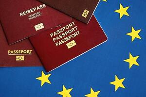 European union countries passports on blue EU flag close up photo