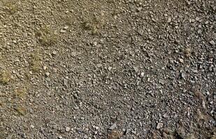 Background of shattered stony stones surface in mountain area. Texture with natural light photo