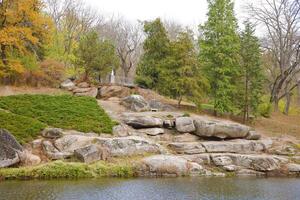 Beautiful Nature Autumn landscape with lake. Scenery view on autumn city park with golden yellow foliage in cloudy day photo