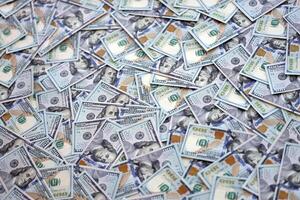 Very big amount of US hundred dollar bills. Huge quantity of united states currency notes on flat table photo