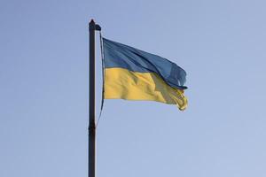 Ukraine flag large national symbol fluttering in blue sky. Large yellow blue Ukrainian state flag, Dnipro city, Independence Constitution Day photo