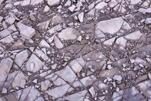 Background of shattered stony stones surface in mountain area. Texture with natural light photo