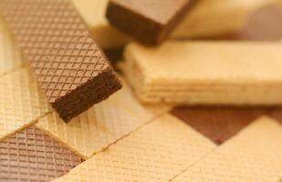 Stacked delicious chocolate wafers in large amount. Two different flavours of classic waffles photo