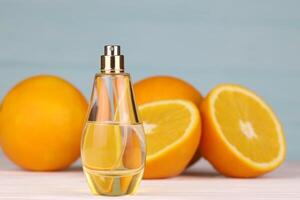 Perfume with citrus extracts. Selective focus. Spa day, concept of freshness perfume bottle with lemon lime and orange photo