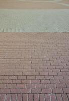 A large area, covered with a quality paving stone in daylight photo
