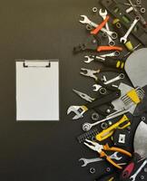 Handyman tool kit on black wooden table. Many wrenches and screwdrivers, pilers and other tools for any types of repair or construction works. Repairman tools photo