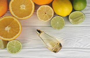 Perfume with citrus extracts. Selective focus. Spa day, concept of freshness perfume bottle with lemon lime and orange photo