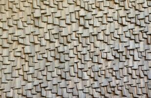 Gray wooden roof tiles background texture. A close up of old gray roof covered with wooden tiles photo