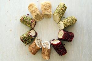 Rolls of turkish delight with different flavors and fillings close up on table photo