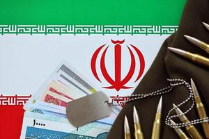 Many bullets and iranian rials money bills on flag of Islamic Republic of Iran photo