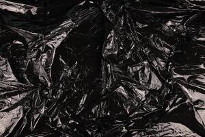 Texture of black plastic garbage disposable bag photo