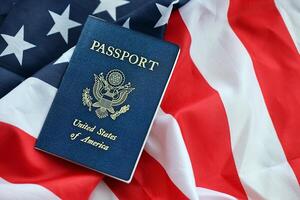 Blue United States of America passport on national flag background close up photo