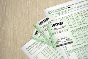 Green lottery tickets and blank bills with numbers for playing lottery photo