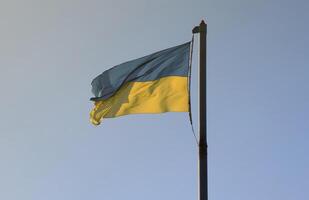 Ukraine flag large national symbol fluttering in blue sky. Large yellow blue Ukrainian state flag, Dnipro city, Independence Constitution Day photo