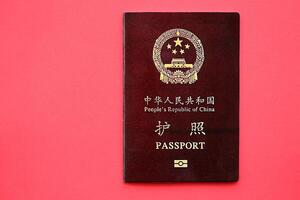 Red passport of People Republic of China. PRC chinese passport on bright background photo