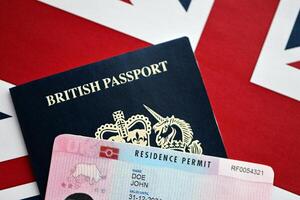 Residence Permit BRP card and British Passport of United Kingdom on Union Jack flag photo