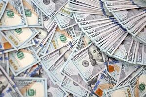Very big amount of US hundred dollar bills. Huge quantity of united states currency notes on flat table photo