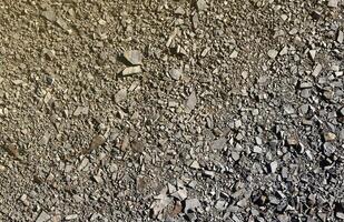 Background of shattered stony stones surface in mountain area. Texture with natural light photo