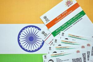 Indian Aadhaar card from Unique Identification Authority of India on Indian flag photo