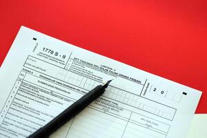 Indonesian tax form 1770 S - 2 Individual Income Tax Return and pen on table photo