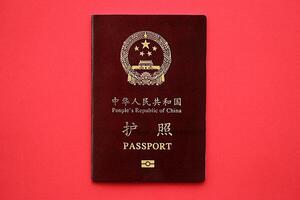 Red passport of People Republic of China. PRC chinese passport on bright background photo