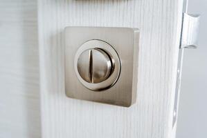 Round door lock, internal locking element of the door handle, chrome detail, latch on the door. photo