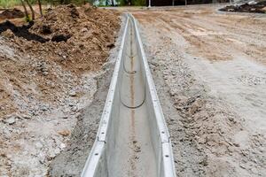 drenaje sistema para aguas residuales en el la carretera. construcción de un canal para el descarga de agua de lluvia. construcción de el calzada. abandone para drenando. foto