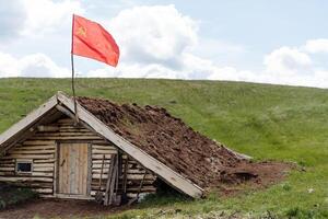 The flag of the Red Army, a military structure, an underground dugout, a command post of the Russian military forces, a dugout against airstrikes, wartime, a wooden structure. photo