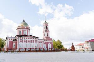 The Orthodox Church stands on the city square, the Pink Temple, the city of Birsk Bashkortostan, a beautiful building of ancient Christianity. dome of gold metal. photo