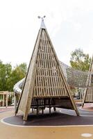 A wooden pyramid made of boards, an amusement park, a lapel for children, a tower for hide and seek. photo