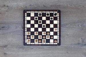 The chess board with the pieces in the dark vintage room photo