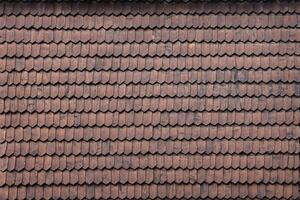 Gray wooden roof tiles background texture. A close up of old gray roof covered with wooden tiles photo