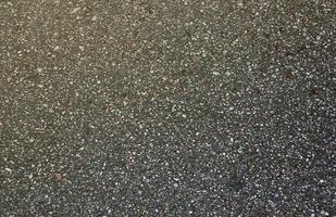 Surface grunge rough of asphalt. Tarmac dark grey grainy road. Texture Background Top view photo