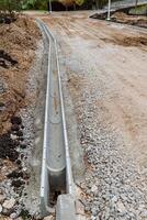 Road construction, a ditch for draining water, the side of the roadway, a sewer drain hollow. roadworks. photo