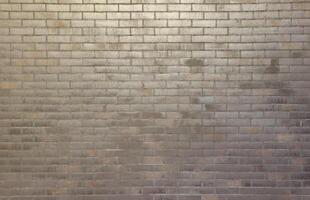 Dark brick wall pattern with chaotic masonry order. Background texture or resource for 3d texturing. Many bricks in big modern stone wall photo