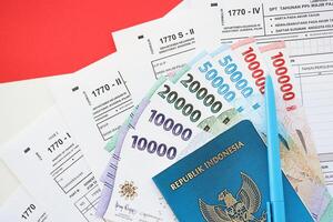 Indonesian tax forms 1770 Individual Income Tax Return and passport with pen on table photo