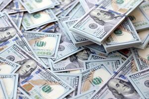Very big amount of US hundred dollar bills. Huge quantity of united states currency notes on flat table photo