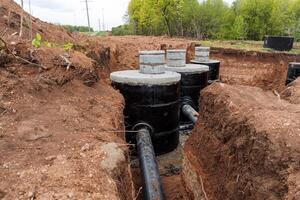 Sewerage trench, pipeline repair, plastic water pipes, PVC material, concrete structure, pipe waterproofing. photo