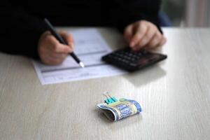 Accountant start to fill Iranian tax form on office table. Taxation period and annual taxpayers routine photo