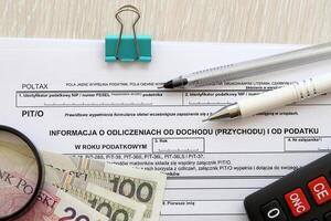 Information about deductions from income and tax, PIT-O form on accountant table with pen and polish zloty money bills photo