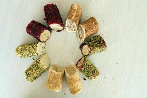 Rolls of turkish delight with different flavors and fillings close up on table photo