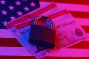 US Employment authorization card with small padlock on United States flag photo