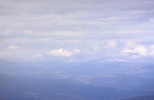 Beautiful cloud formations in the sky with sunlight behind. White clouds on dramatic blue sky photo