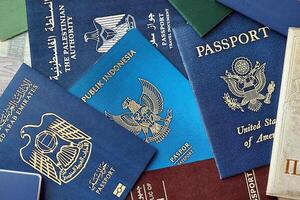 Many various passports of citizens of different countries and regions of the world photo