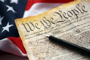 Preamble to the Constitution of the United States and American Flag close up photo